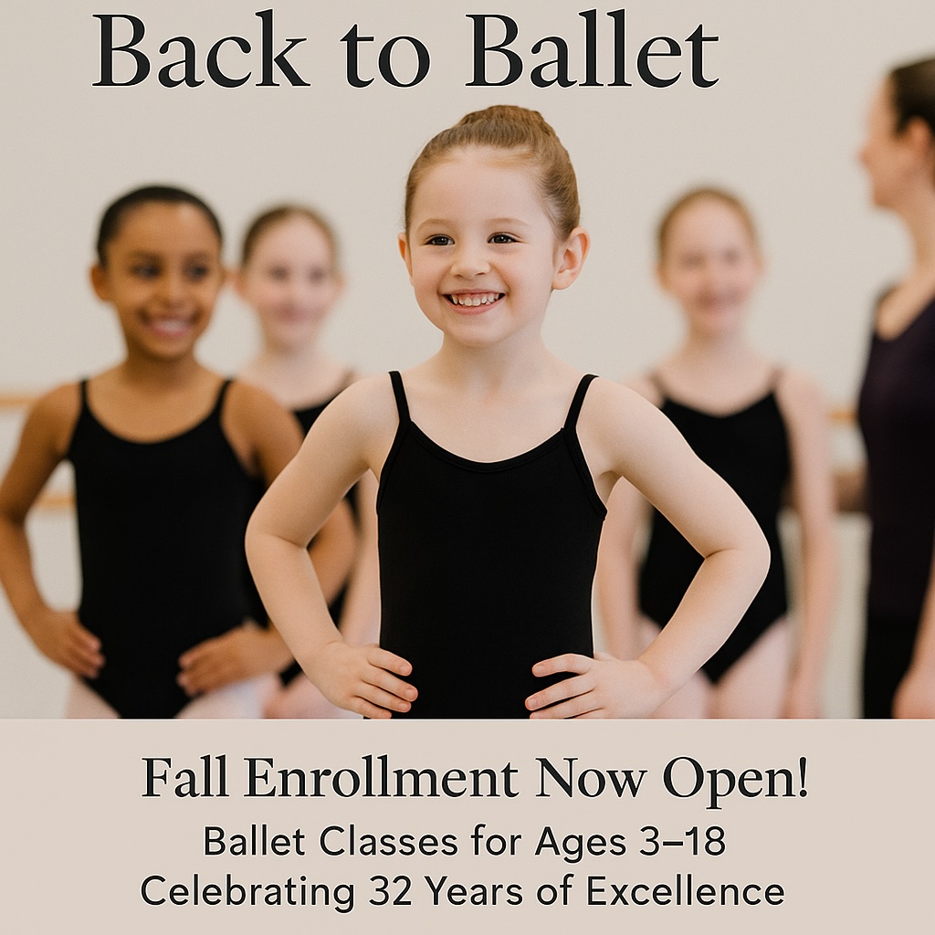 Young ballet student smiling confidently in a black leotard with classmates blurred in the background.