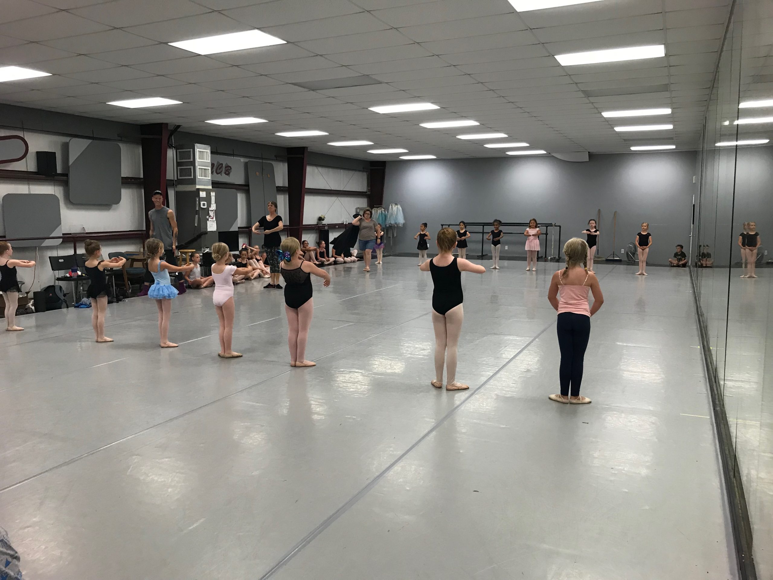 Young ballet students practicing at the barre in a professional dance studio at North Central Ballet in Keller, TX.