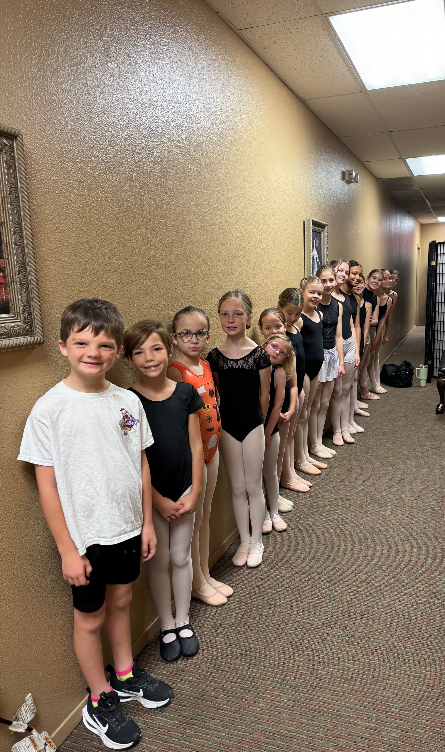 Homeschool and academy ballet students lined up in leotards and tights, preparing for class at North Central Ballet in Keller, TX.